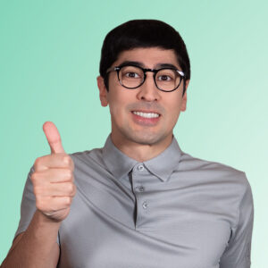 Cid Jay Kei looks at the camera with a thumbs up, wearing a buttoned-up gray polo and round glasses, with an awkward smile.